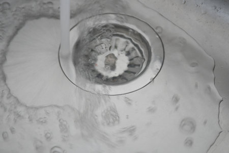 water pouring from a faucet tap slow motionの写真素材