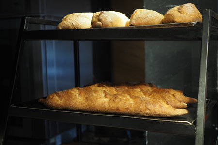 Freshly baked bread lies on the shelves ready for sale.の写真素材