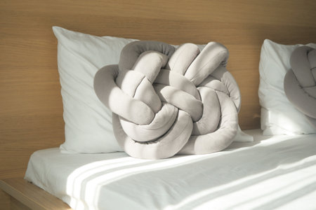 gray color pillow on bed at early morningの写真素材