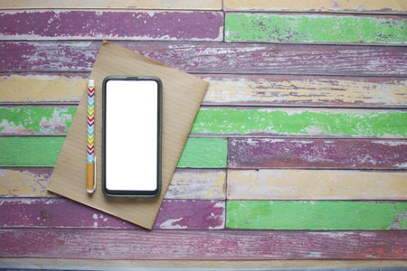 top view of smart phone and notepad on table