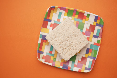 top view of slice of tofu on a chopping board on table