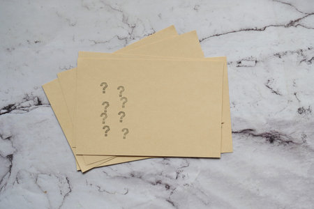 high angle view of question mark on paper on office desk