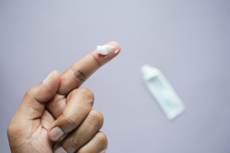 Man applying antibiotic cream close upの写真素材