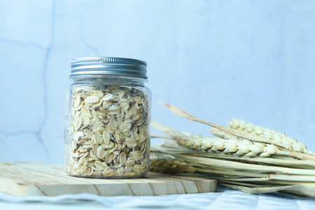 roasted oats flakes in a jar on tableの写真素材