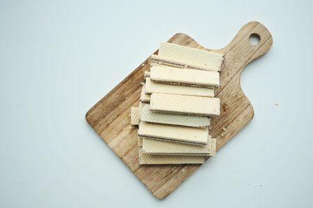 top view of wafer roll chocolate on wooden board on tableの写真素材