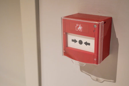 Red fire alarm button on wall ,