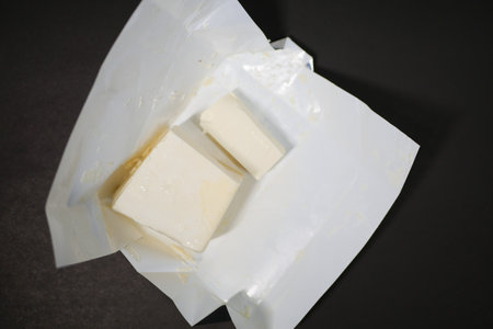 slice of a butter on a paper on tableの写真素材