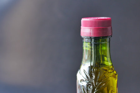 bottle of olive oil against black background