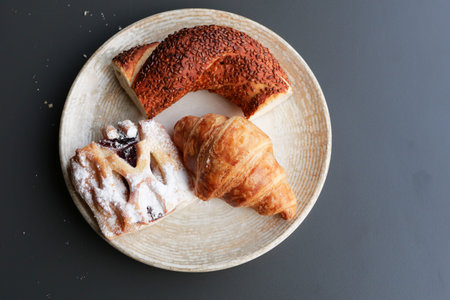 fresh baked croissant and bread on plate