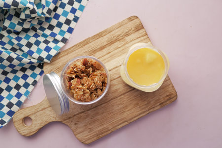 Granola Musli and lemon flavor yogurt preserved n a jar on tableの写真素材