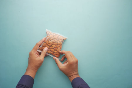 men holding a almond nut packetの写真素材