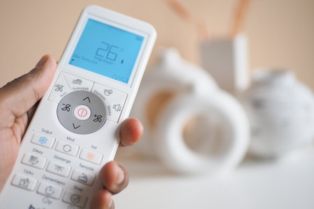 Close up of man hand holding air condition remote.の写真素材