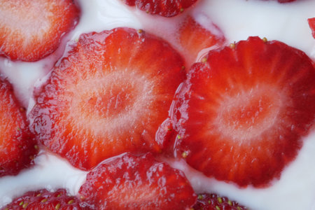 Ripe Red Strawberries and cream milk in a bowl on tableの写真素材