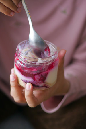 women eating chocolate pudding in a glass jarの写真素材