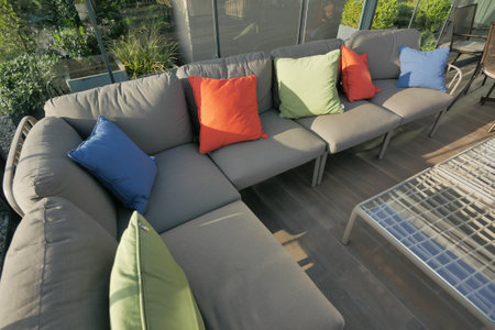 modern grey sofa with pillows in living room at homeの写真素材