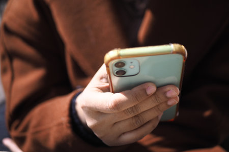 close up of women hand holding smart phoneの写真素材