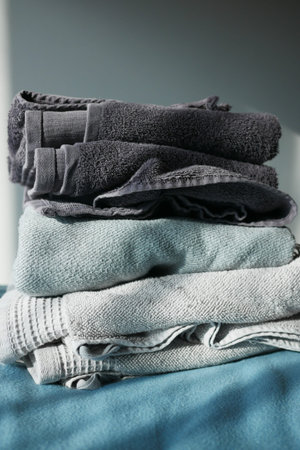 Close up of stack of shower towel on table.