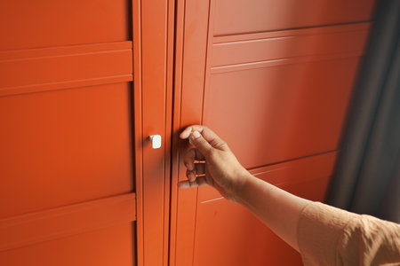 women hand opening bedroom cabinet doorの写真素材