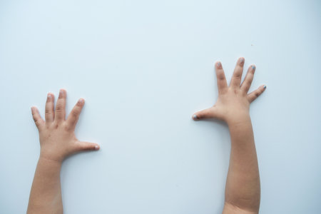 nervous child hand on light white backgroundの写真素材
