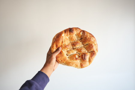 POV shot of holding a Ramadan Pide, Turkish popular bread,の写真素材