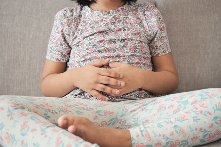 child suffering stomach pain close up.の写真素材