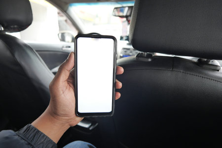 men hand holding smart phone with empty screen in a car