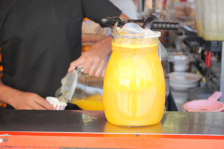 orange juice jar on a tableの写真素材