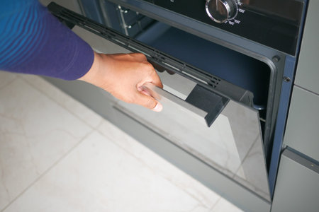 men hand open a electric oven