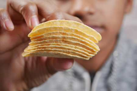 men eating potato chips closeupの写真素材