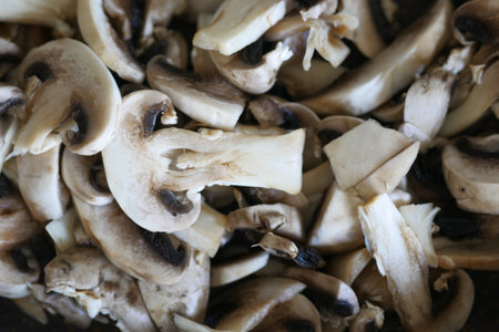 Fresh champignons mushroom in a white bowl on tableの写真素材