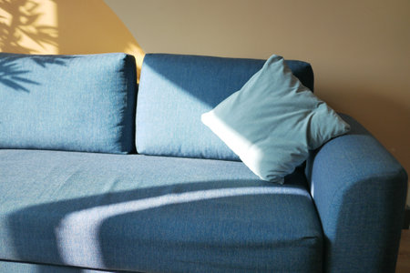 modern grey sofa with pillows in living room at homeの写真素材