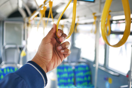 Hand holding handle on the public transport