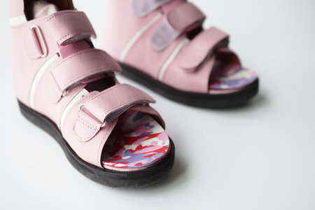 Child cerebral palsy legs orthosis shoes on white backgroundの写真素材
