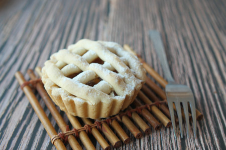 Homemade apple pie with lattice pastry on table