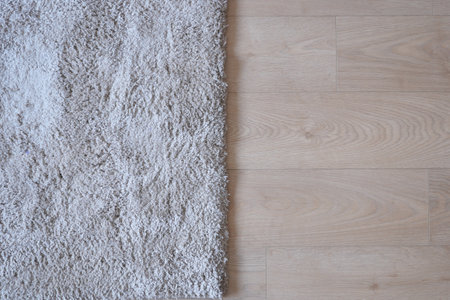 Seamless grey carpet texture background on wooden floor with copy spaceの写真素材