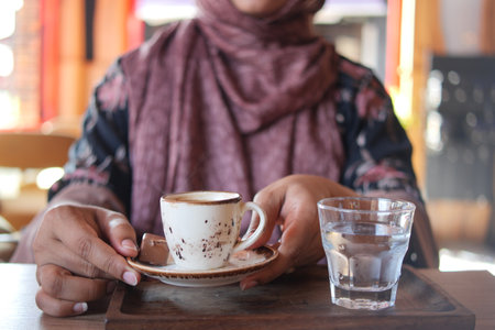 women holding a a cup of turkish coffee on tableの写真素材