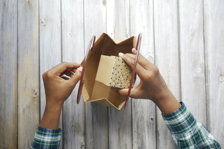 bring out gift box from a shopping bag .の写真素材