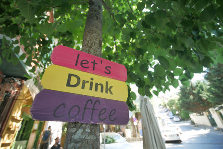 A sign at a coffee shop offering different types of coffee.