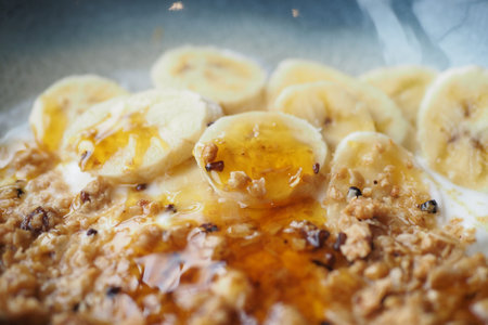 detail shot of granola Musli honey and banana in a bowl,