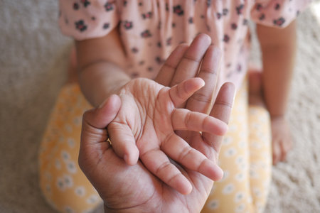 father holding hand of baby child, close up .の写真素材
