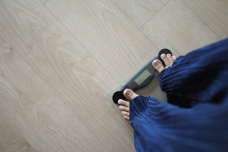 young women feet on weight scale top view