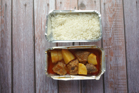 traditional Indian curry lamb masala in a take away packet on tableの写真素材