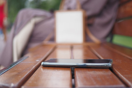 forget smartphone on a park bench, lost smart phoneの写真素材