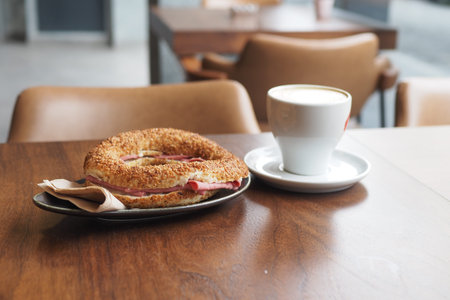 Sandwich With Smoked Chicken Salami and coffee on tableの写真素材