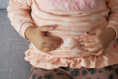 child suffering stomach pain close up.の写真素材