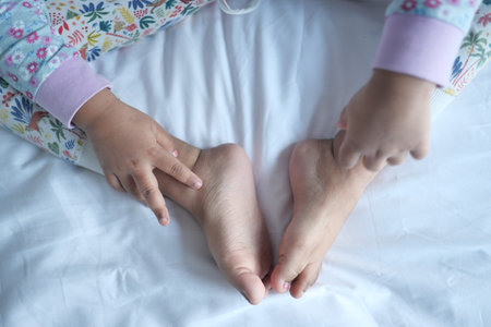 child girl suffering from itching skin, close up.