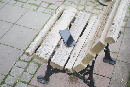 forget smartphone on a park bench, lost smart phoneの写真素材