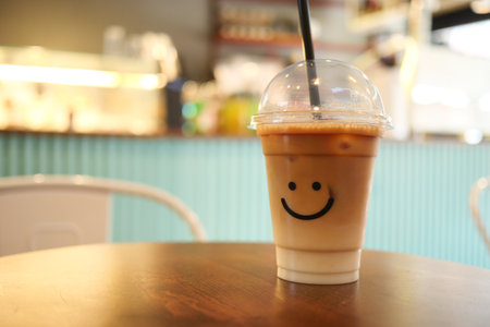 cold coffee in a plastic container with smile shape design on itの写真素材