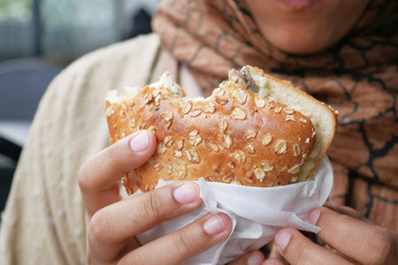 women hand holding beef burgerの写真素材
