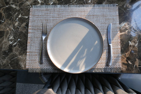 fork, knife and a circle shape plate on table